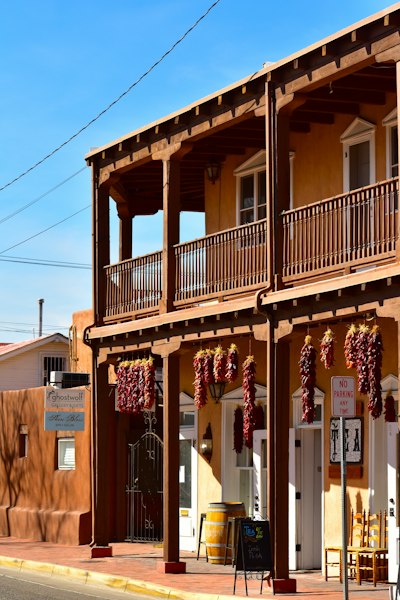 a building with a bunch of red peppers hanging from it's balconies