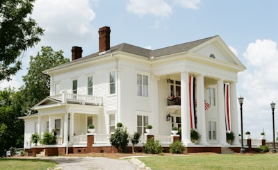 A grand white house with columns and banners