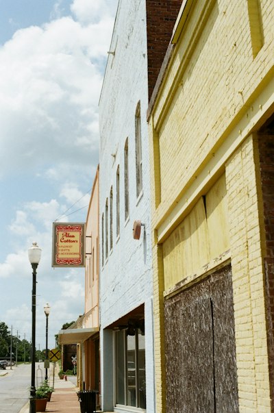 Quaint streetscape featuring colorful old buildings and an antique sign