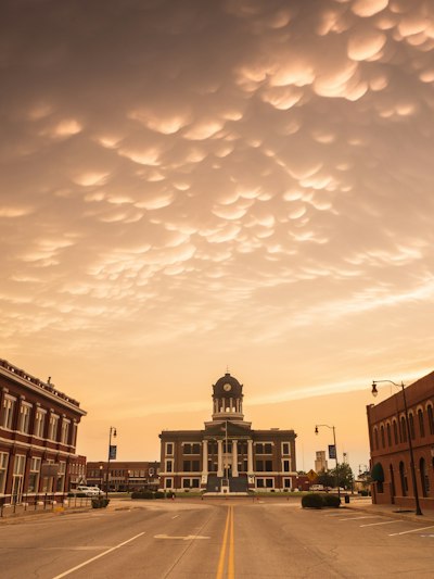 brown concrete building under cloudy sky during daytime