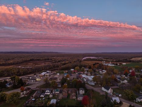 Aerial view of Nelson, Wisconsin during a vibrant sunset with dramatic clouds and colorful landscape.