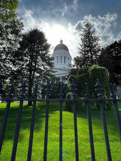 a white building behind a fence