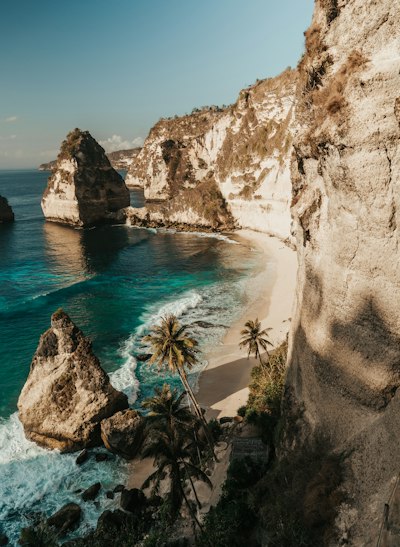 Diamond Beach with white sand and turquoise water below limestone cliffs in Nusa Penida