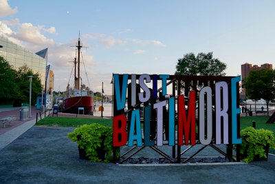 A sign that says visit baltimore on it