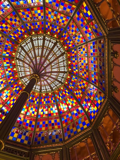 a colorful stained glass ceiling in a building