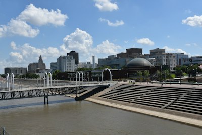 a bridge over a river with a city in the background