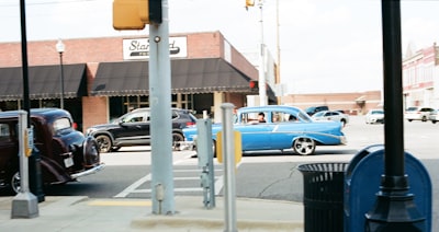 Classic cars driving on a town street