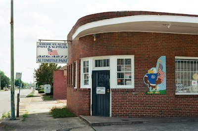 Brick building with american auto paint sign