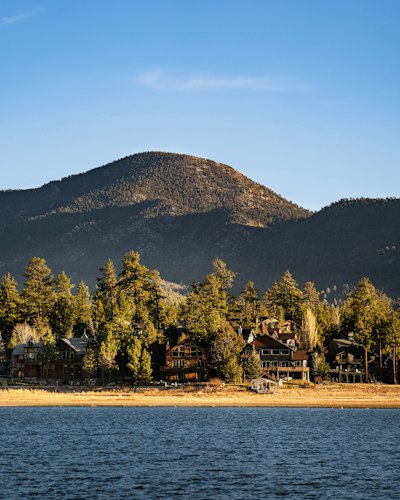 a large body of water with a mountain in the background