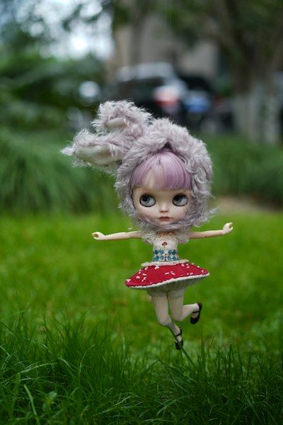 A doll is flying through the air in the grass