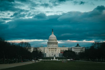 the capitol building in washington dc under a cloudy sky