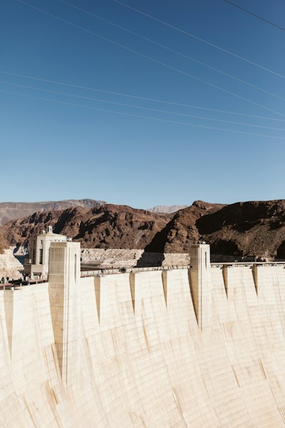a view of a dam with mountains in the background