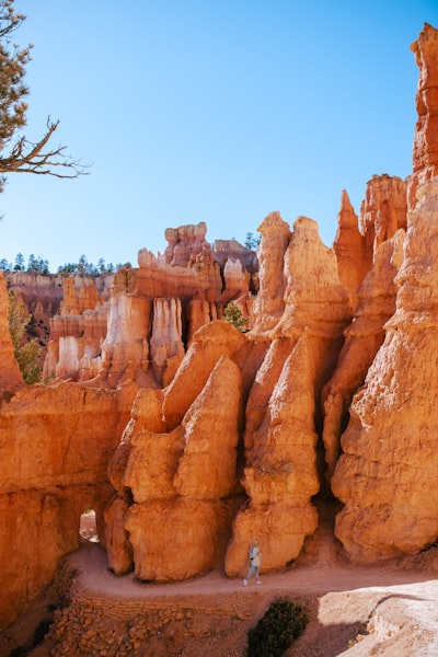 a person standing in front of a rock formation