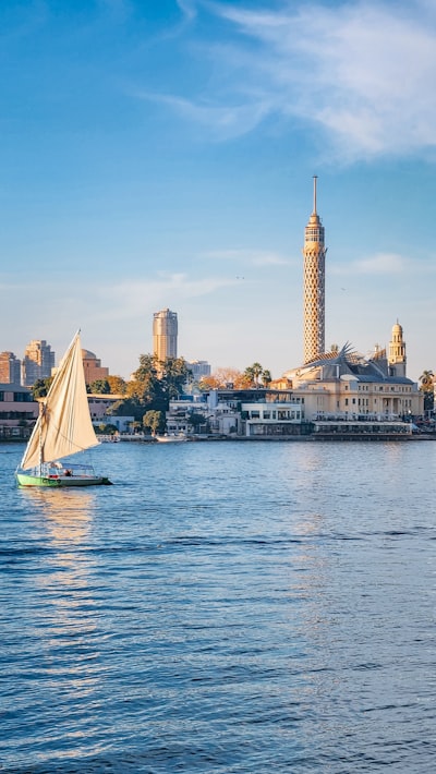 A felucca sailing on the Nile River with the Cairo Tower in the background