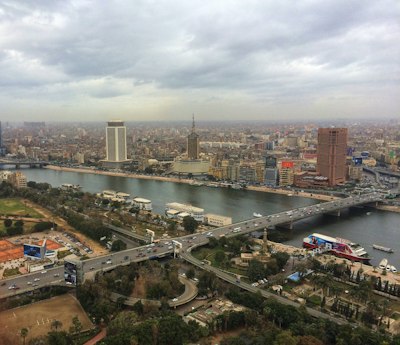 ferries along the city river banks near bridge with crossing cars