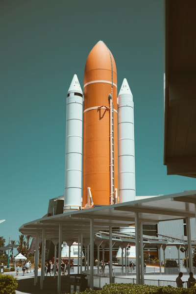 a large orange rocket sitting on top of a building