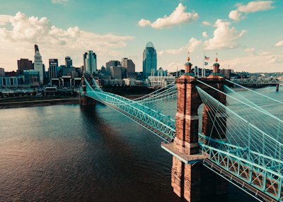 bridge over water near city buildings during daytime