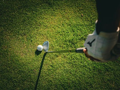 a person swinging a golf club