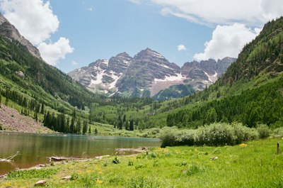 Mountains and lake meet under a sunny sky