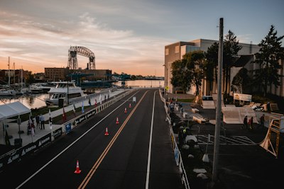 A view of a city street with boats parked along the side of the road