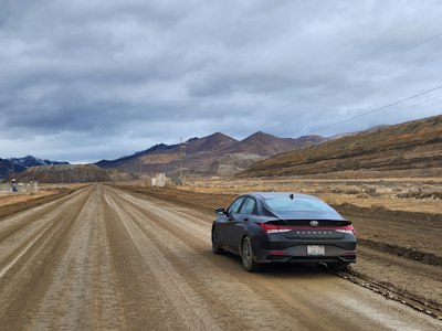 a car parked on a dirt road in the middle of nowhere