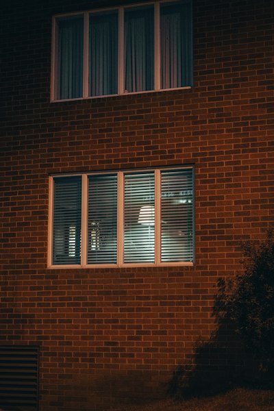 white wooden window frame on brown brick wall