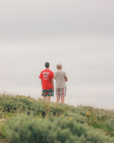 Two people stand and gaze at the sky