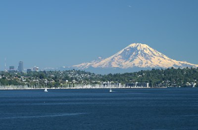 A large body of water with a mountain in the background