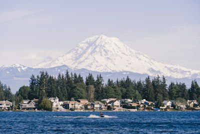 a boat in the water with a mountain in the background
