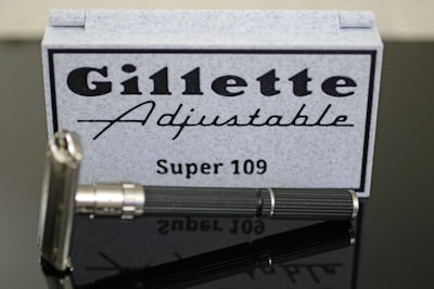 A gillette adjustable super 109 razor with its case