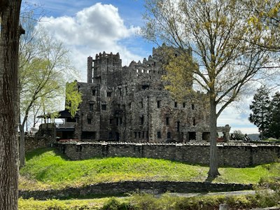 a large castle like building sitting on top of a lush green field