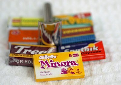 Multiple razor blade packages, featuring a yellow gillette minora box