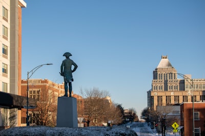 a statue of a man standing in the middle of a street