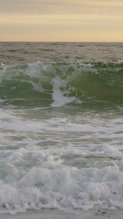 a man riding a wave on top of a surfboard