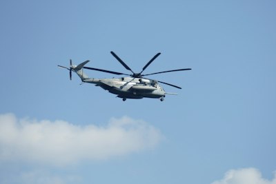 white and black helicopter flying in the sky during daytime