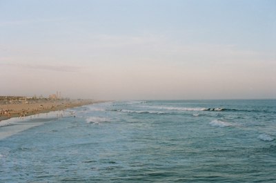 body of water under white sky during daytime