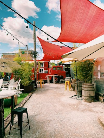 red and white wooden building near green trees during daytime
