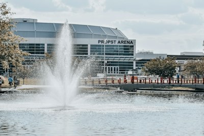 a water fountain in front of a large building