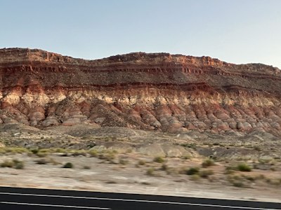 a view of a mountain from a moving car