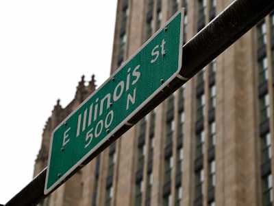 a street sign in front of a tall building