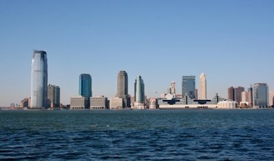 city skyline across body of water during daytime