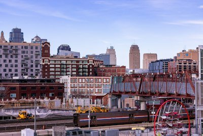 a train traveling across a bridge over a city
