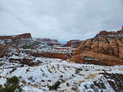 a snow covered landscape with mountains in the background