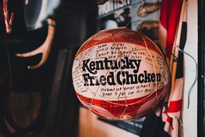 a red and white ball with the words kentucky fried chicken on it