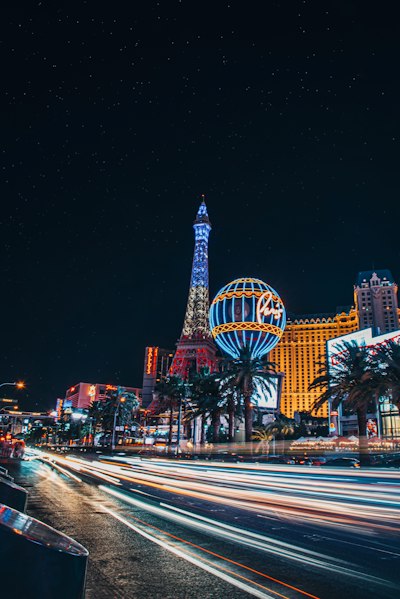 the las vegas strip at night with the eiffel tower in the background