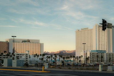 Tall hotels and palm trees at sunset