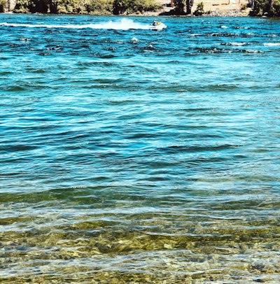 wavy blue body of water during daytime