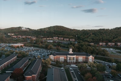 an aerial view of a college campus and parking lot
