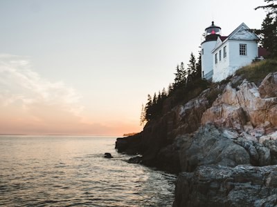 white lighthouse near sea at daytime