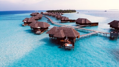brown wooden cottage on blue body of water during daytime
